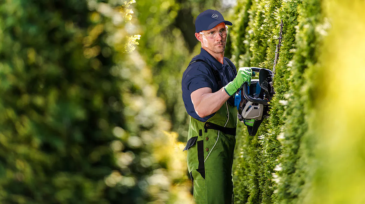 A worker tends to exterior landscaping tasks