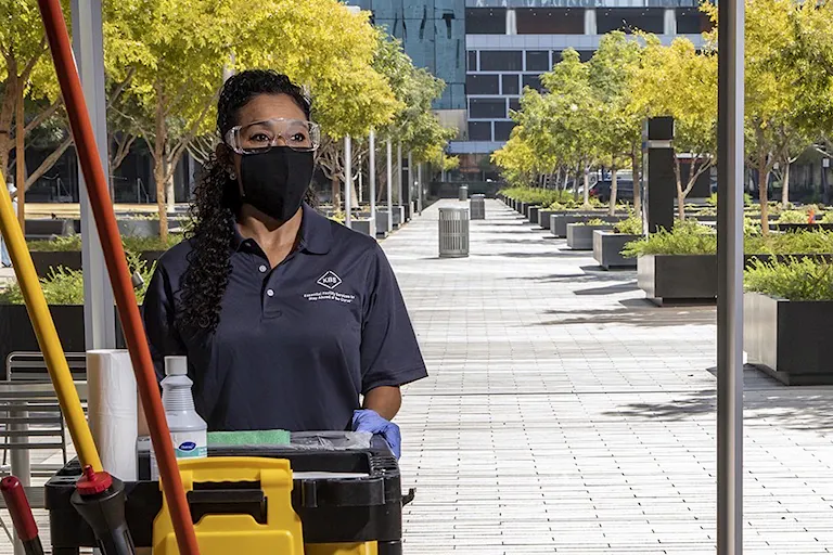 Commercial janitor sanitizes workspace during the Covid-19 Pandemic