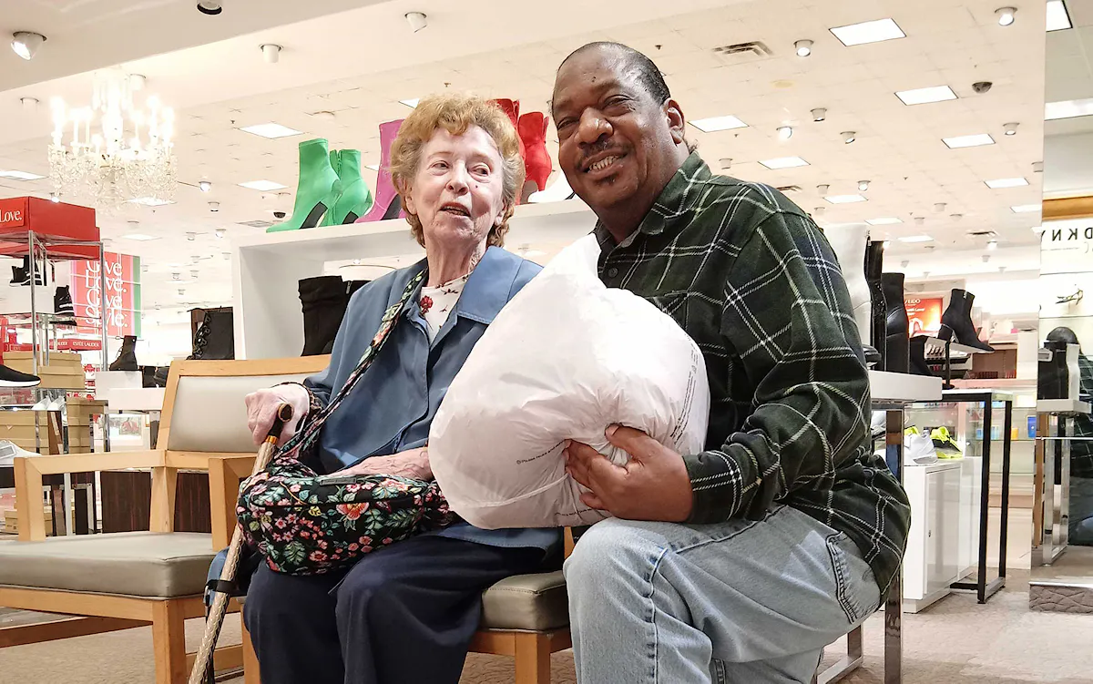 Richardson takes time to help an elderly customer find what she needs for a birthday party.
