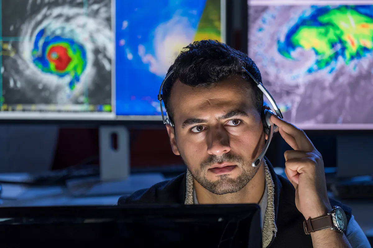 Facility manager communicating with team in a storm
