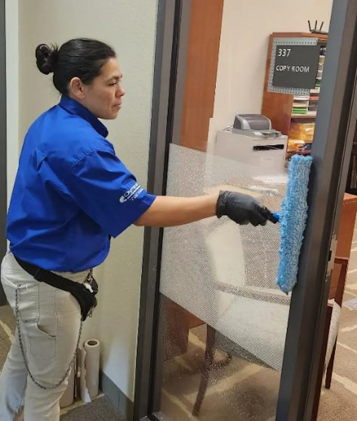 KBS crew member cleans an office window