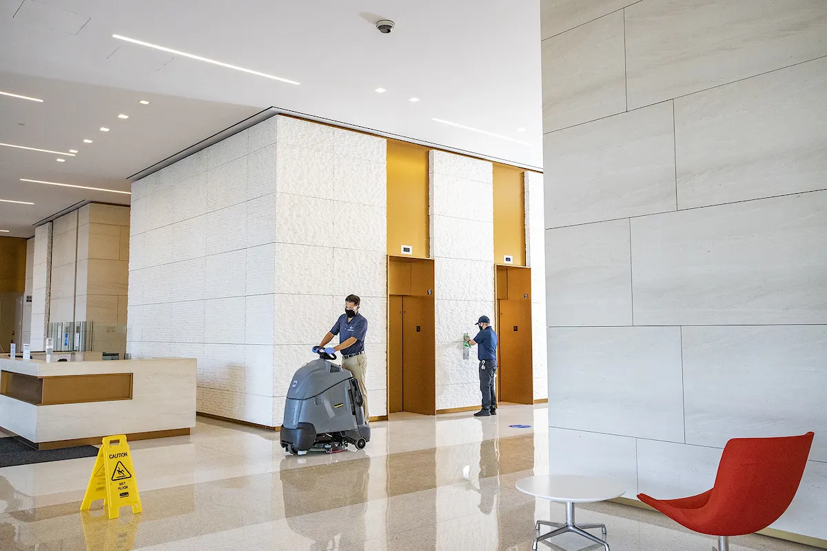 KBS crew member manages floor cleaning in a large office building