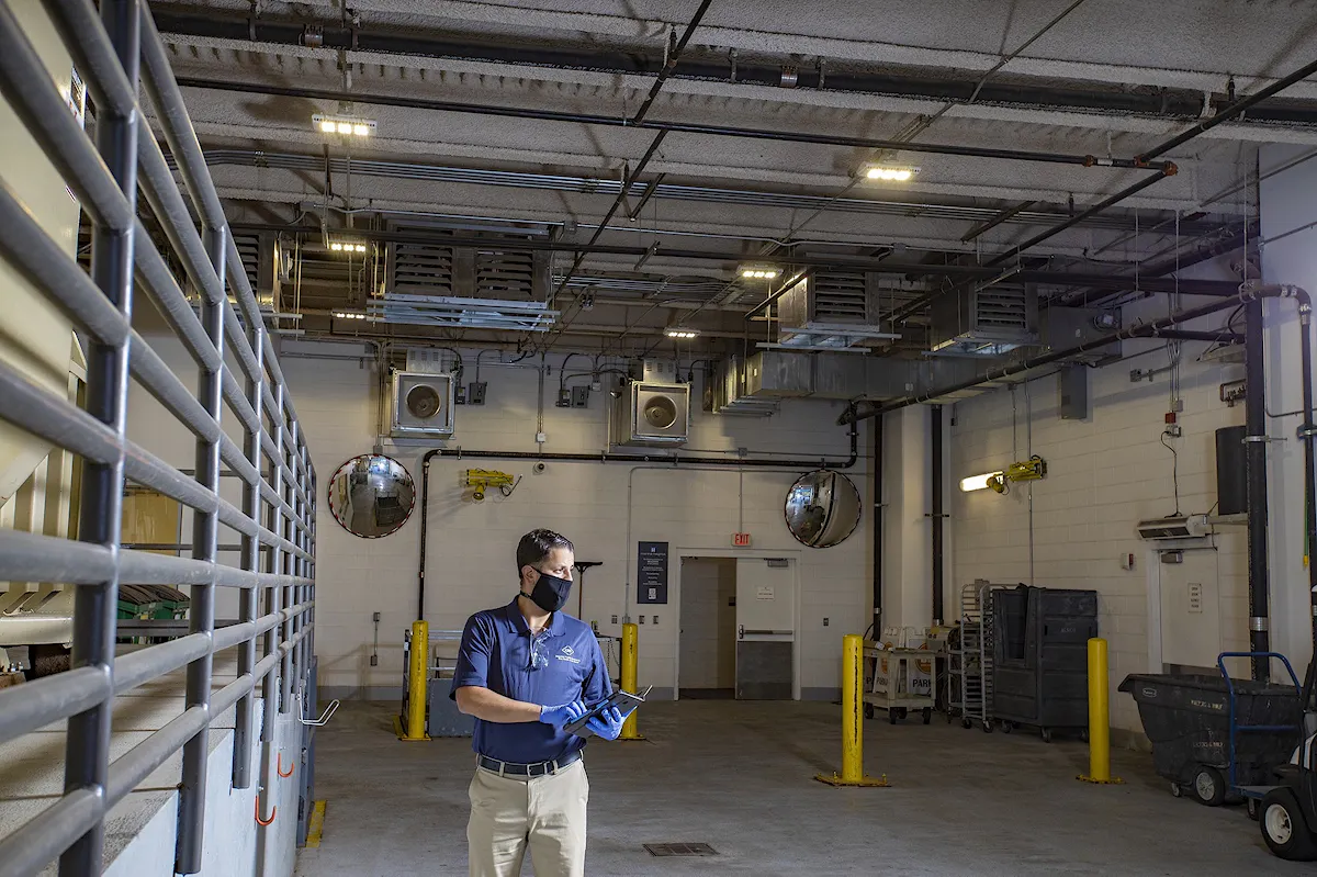 KBS crew member inspects a client facility for cleanliness and compliance